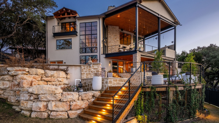 Transitional custom home facade with stone and wood accents